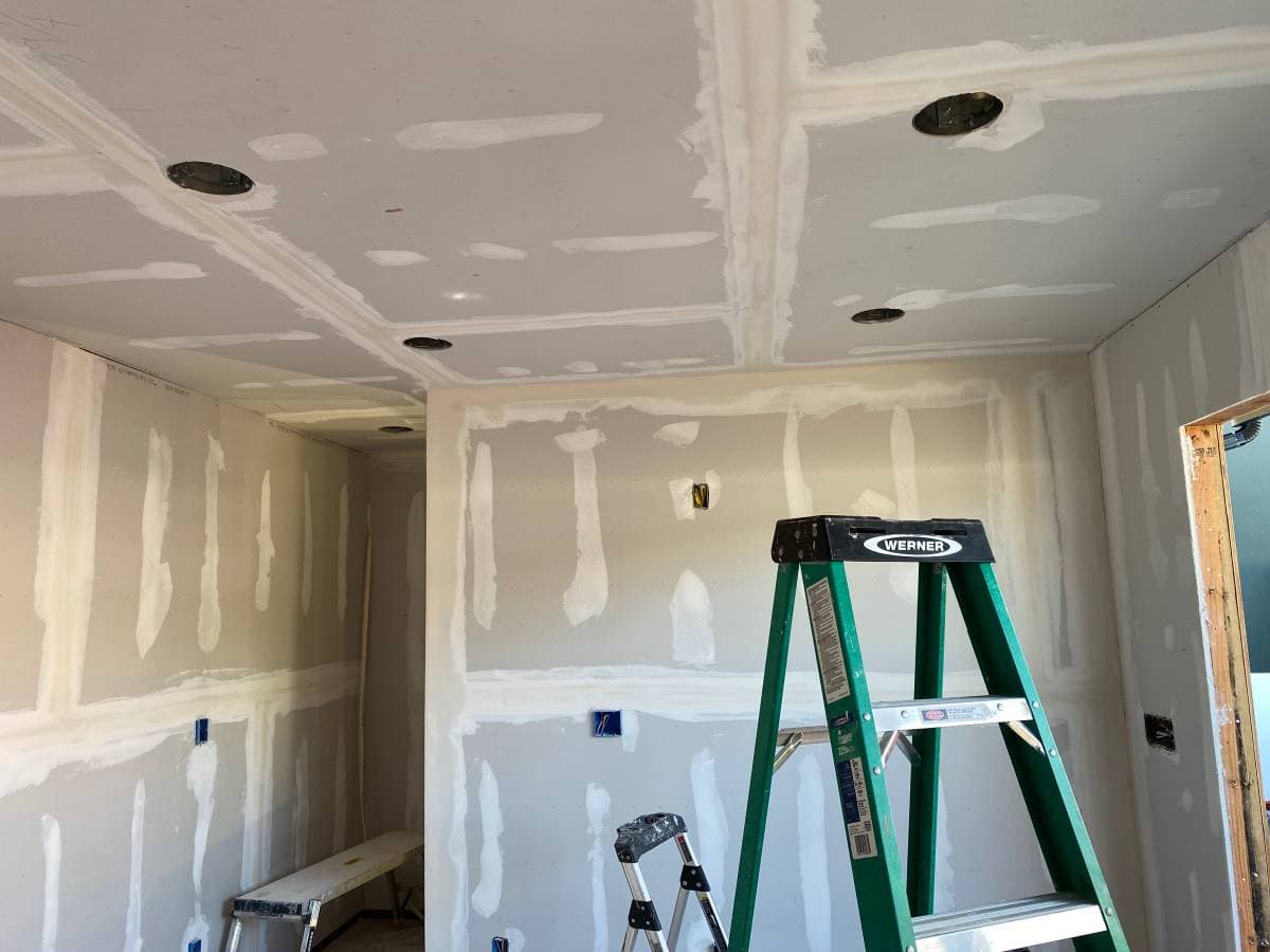 picture of a contractor working on drywall